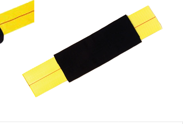 A protective sleeve fitted over yellow strap webbing, shielding it where it crosses a load edge