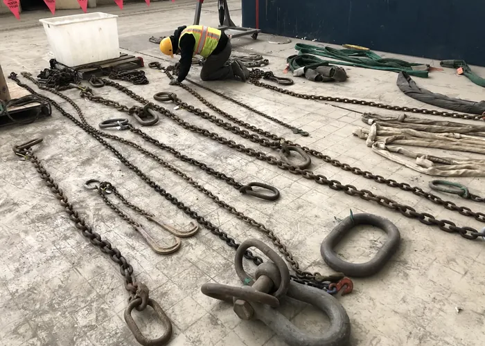 Wire rope slings laid out on a plant floor for inspection