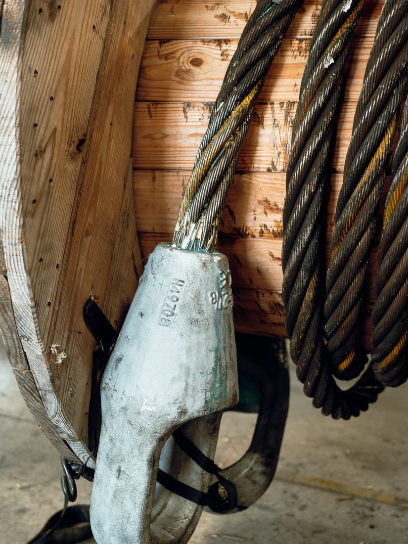 A finished poured socket on a wire rope pendant, with the coiled rope and its reel behind it